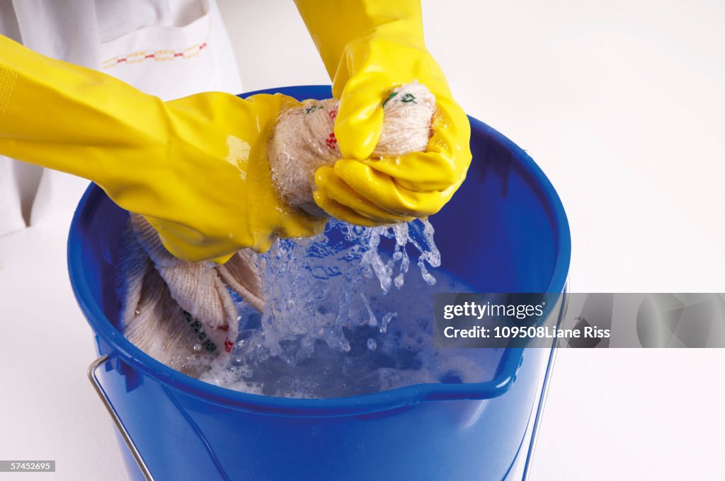 Woman wringing out cleaning rag, elevated view