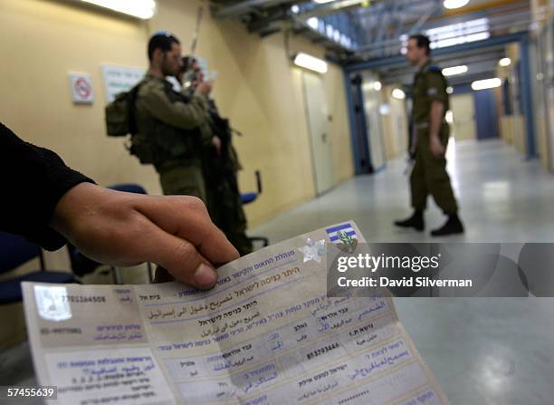 Palestinian youth Abdel el-Raouf Albeek, 15-years-old, shows the Israeli army documents giving him special permission to cross into Israel for violin...