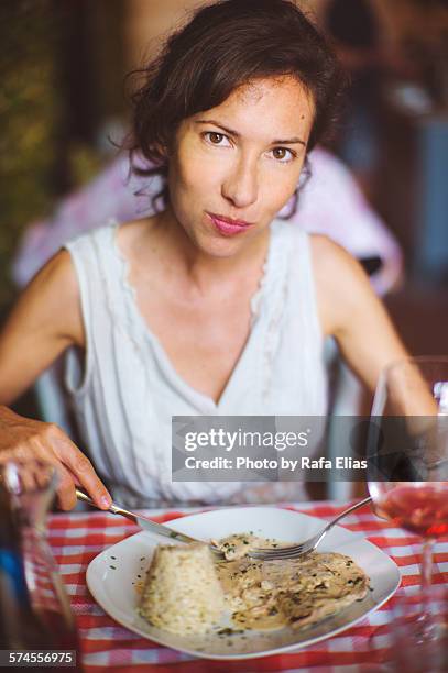 pretty woman eating in italian trattoria - veal-piccata stock pictures, royalty-free photos & images
