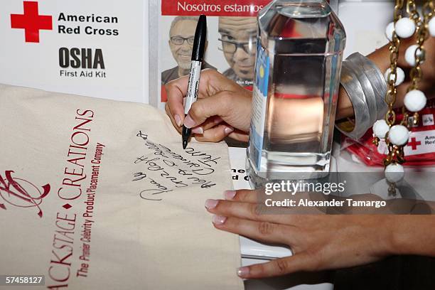 Television personality and 2006 Premios Billboard host Candela Ferro signs a bag at the celebrity gift retreat presented by Backstage Creations for...