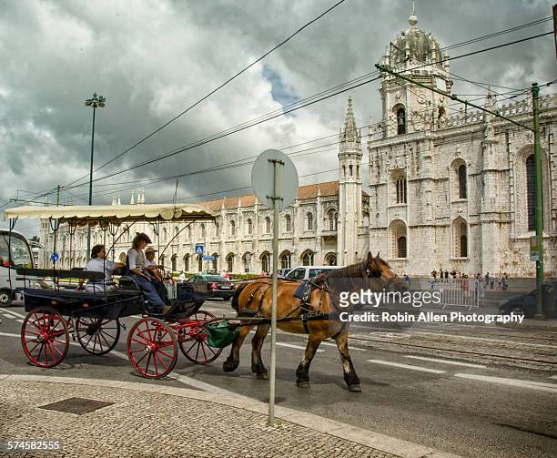 horse-drawn surrey passing jeronimos monastery - surrey wagons stock pictures, royalty-free photos & images