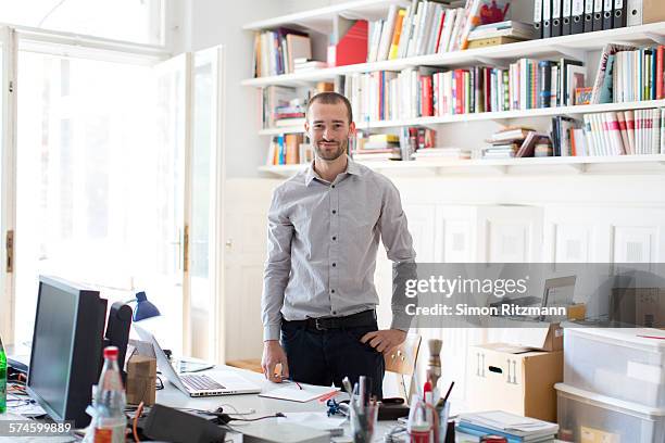 confident young designer in his studio. - högt hårfäste bildbanksfoton och bilder