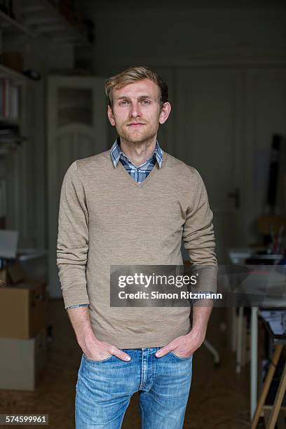 portrait of young architect in his studio. - v neck stock-fotos und bilder