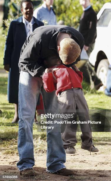 Prince Harry plays with his old friend, Mutsu Potsane, in the grounds of the Mants'ase children's home, while on a return visit to Lesotho in...