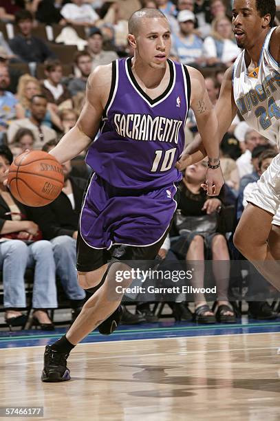 Mike Bibby of the Sacramento Kings drives around Andre Miller of the Denver Nuggets during the game at Pepsi Center on April 15, 2006 in Denver,...