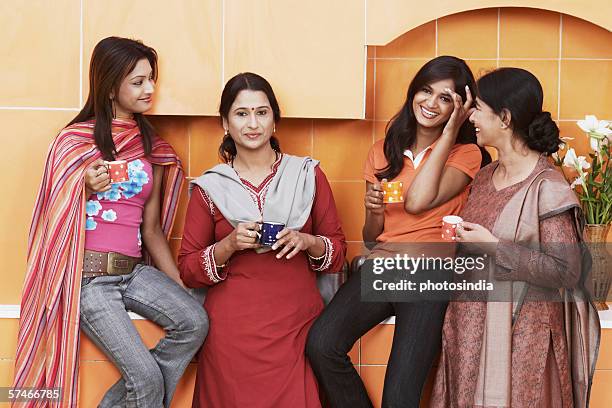 close-up of a mother laughing with her three daughters - hair bun scarf woman stock pictures, royalty-free photos & images