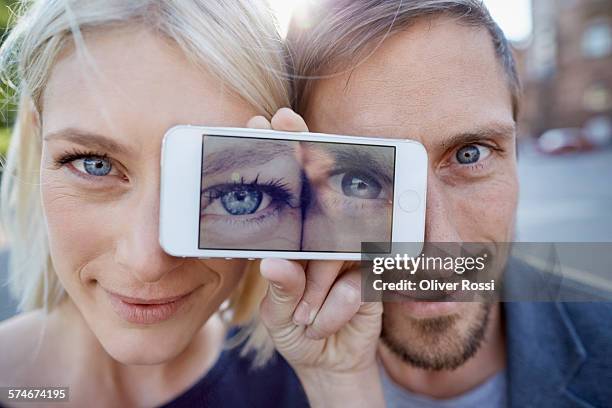 couple showing their eyes on cell phone display - expressive eyes bildbanksfoton och bilder