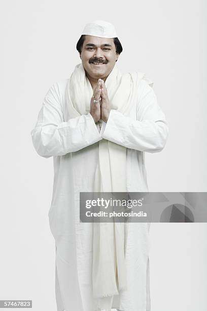 portrait of a mature man in a prayer position - prayer pose greeting stock-fotos und bilder