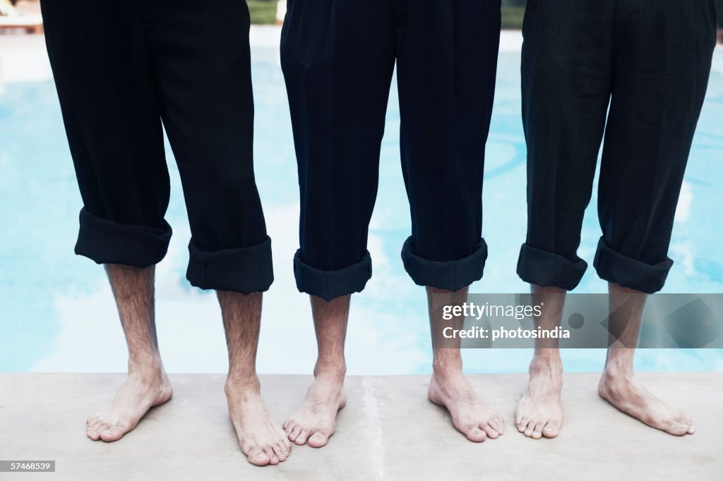 High angle view of three pairs of legs