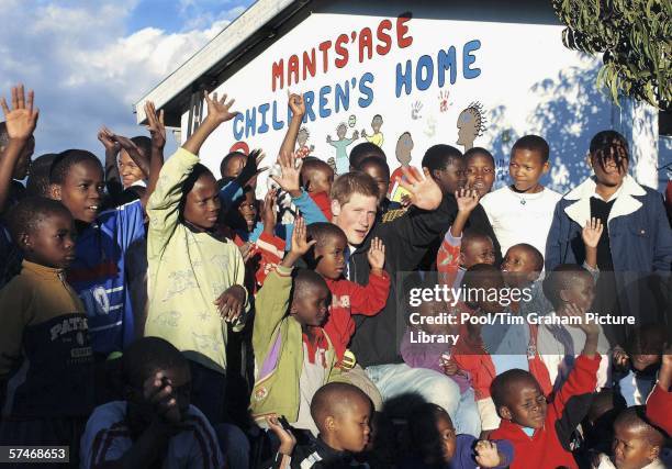 Prince Harry sits with children from the Mants'ase children's home during a return visit to Lesotho in southern Africa on April 24, 2006. The Prince...