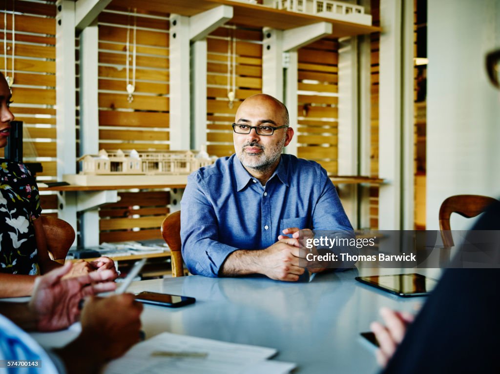 Small business owner listening during meeting