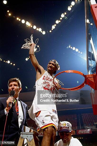 Kenny Smith waves with the net after the Houston Rockets defeated the Orlando Magic in Game four of the NBA Finals to win the NBA Championship at The...
