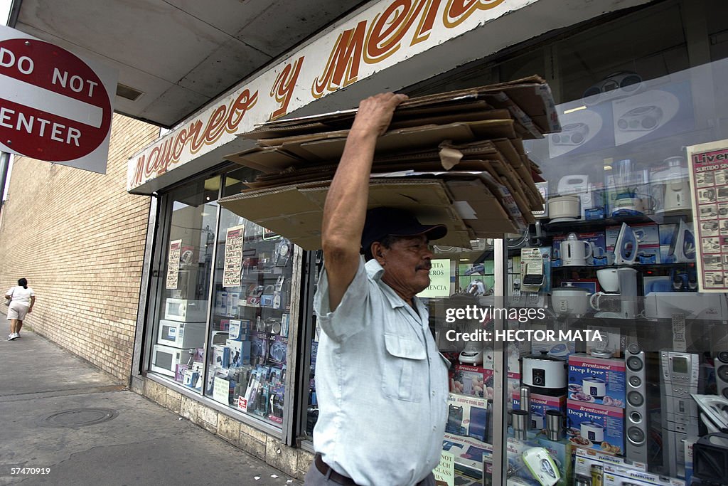 A man carries discarded boxes from an ap