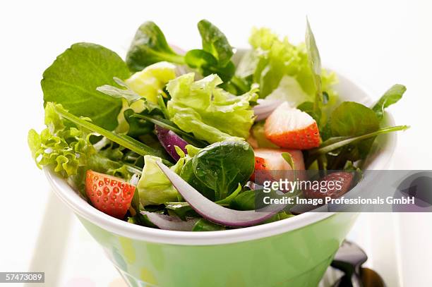 spring salad with red onions and strawberries in bowl - mache stock pictures, royalty-free photos & images