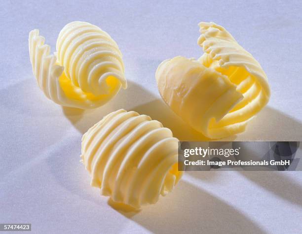 three butter curls - butter curl stock pictures, royalty-free photos & images