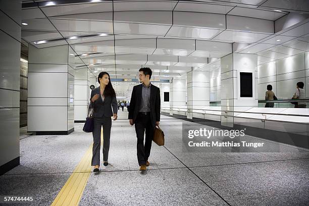 young japanese couple at the airport - arrival ストックフォトと画像