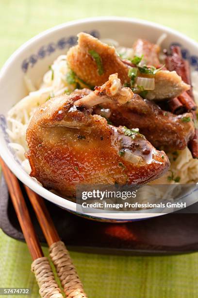 roast pigeon on noodles in asian bowl; chopsticks - roast pigeon stock pictures, royalty-free photos & images