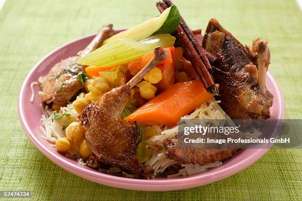 roast pigeon with vegetables and cinnamon sticks on noodles - roast pigeon stock pictures, royalty-free photos & images