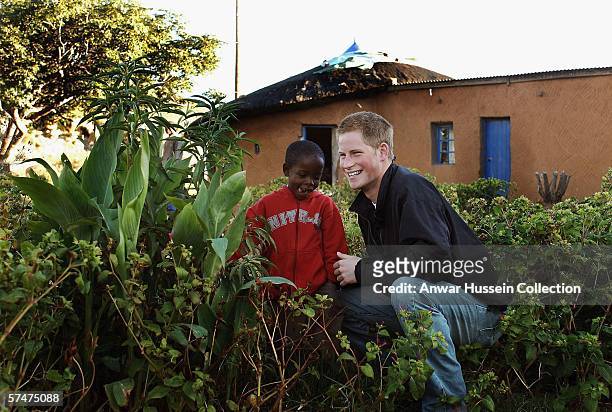 Prince Harry and Mutsu Potsane inspect the Peach Tree that they planted, in March 2004, in the grounds of the Mants'ase childrens home while on a...
