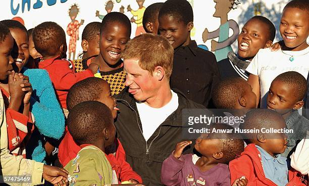 Prince Harry pokes his tongue out at Mutsu Potsane, in the grounds of the Mants'ase childrens home, while on a return visit to Lesotho on April 24,...
