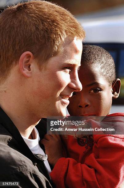 Prince Harry holds his old friend, Mutsu Potsane, in the grounds of the Mants'ase children's home, while on a return visit to Lesotho on April 24,...