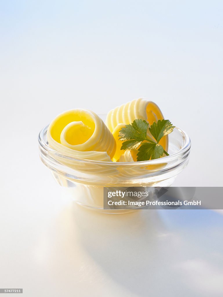 Several butter curls in a small bowl