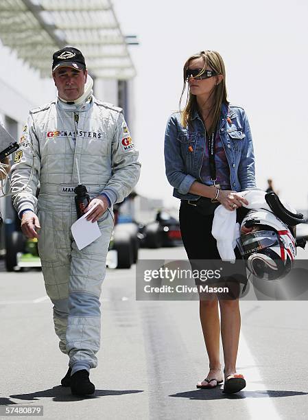 Nigel Mansell of Great Britain walks down the pitlane with his daughter Chloe after third official practice prior to the Grand Prix Masters race at...