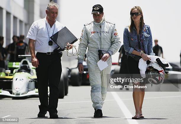 Nigel Mansell of Great Britain walks down the pitlane with his daughter Chloe after third official practice prior to the Grand Prix Masters race at...