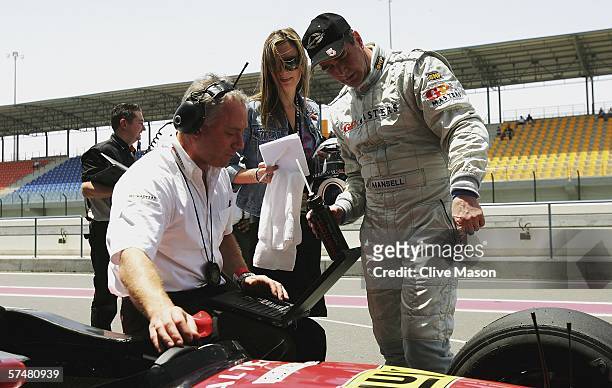 Nigel Mansell of Great Britain talks with his daughter Chloe and his engineer after third official practice prior to the Grand Prix Masters race at...