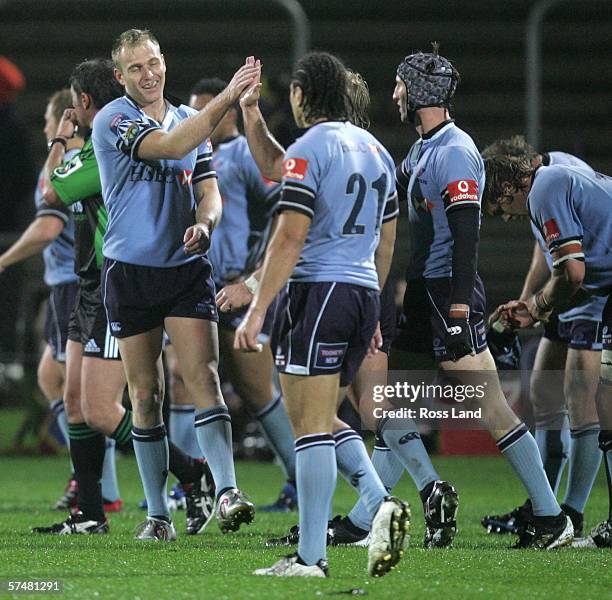 Peter Hewat celebrates with his Waratahs team mates following the round twelve Super 14 rugby match between the Highlanders and the Waratahs at...