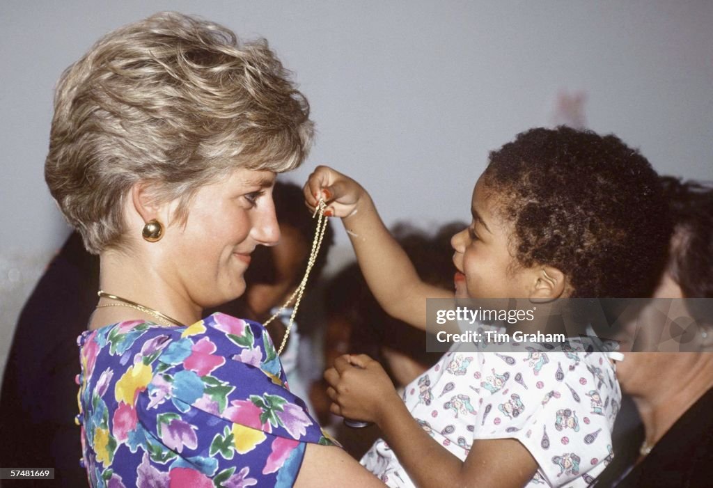 Princess Diana Cuddles Child in Brazil