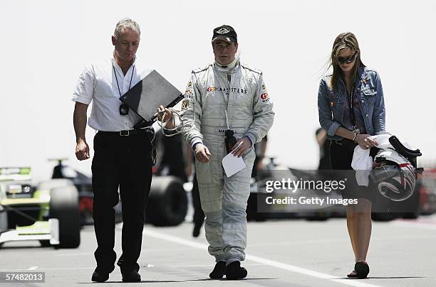 Nigel Mansell of Great Britain walks down the pitlane with a race engineer and his daughter Chloe Mansell during practice ahead of the Grand Prix...