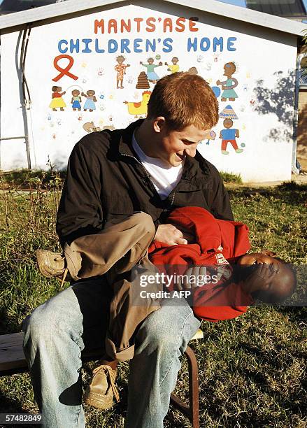 Britain's Prince Harry plays with his old friend Mutsu Potsane in the grounds of the Mants'ase childrens home while on a return visit to Lesotho in...