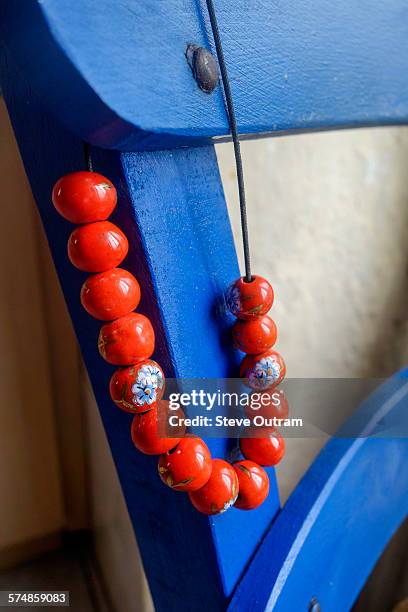 worry beads hanging from a chair - greek worry beads stock pictures, royalty-free photos & images