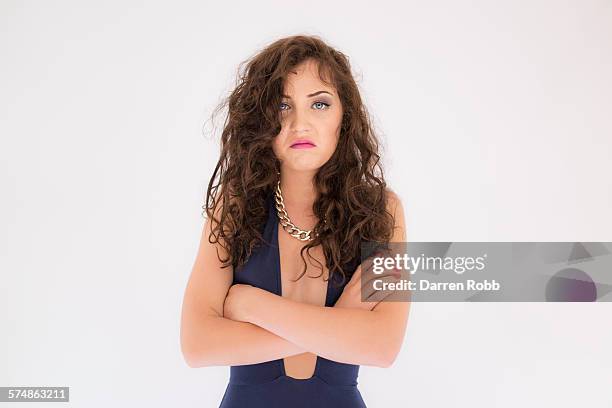 woman with arms folded looking unhappy - decolleté stockfoto's en -beelden