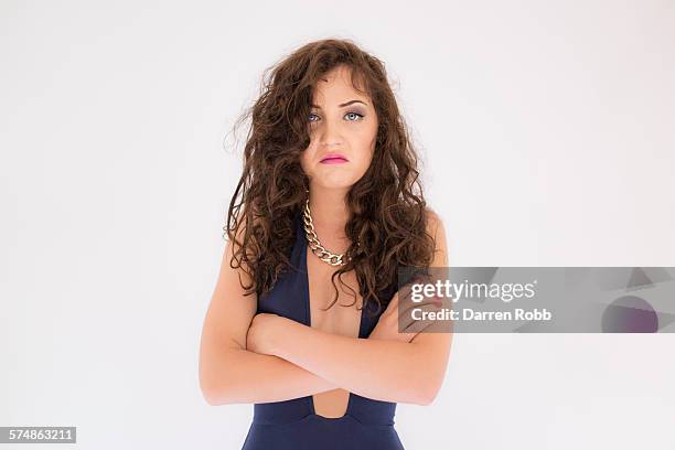 woman with arms folded looking unhappy - female décolletage stock pictures, royalty-free photos & images