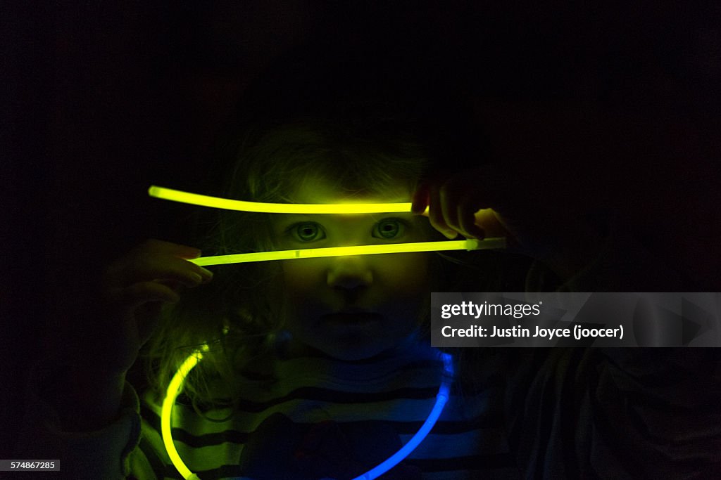 Girl playing with glowing sticks