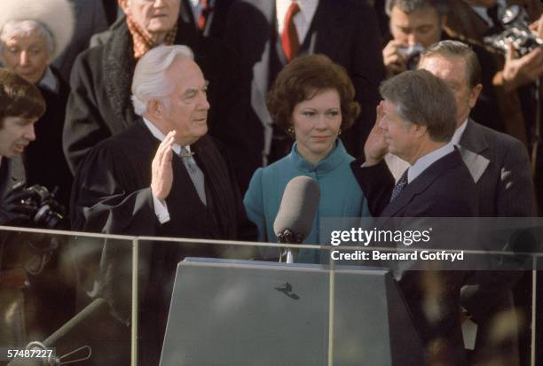 Chief Justice Warren Burger swears in Jimmy Carter as the 39th President of the US at the US Capitol, Washington, DC, January 20, 1977. First Lady...