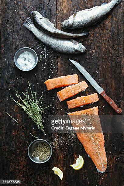 raw fish with herbs - trucha fotografías e imágenes de stock