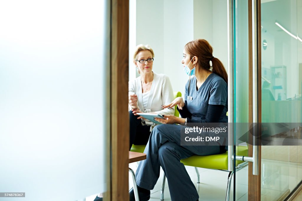 Female dentist discussing report with patient