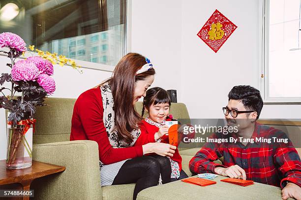 littl girl preparing chinese new year with parent - asian child with new glasses ストックフォトと画像