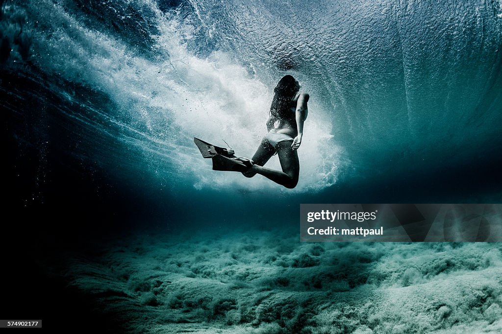 Woman swimming underwater with flippers, Hawaii