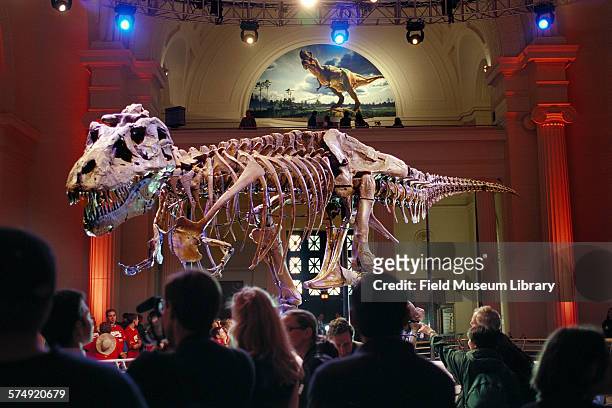 View of the crowd at Stanley Field Hall watching as the skeleton of Sue, Tyrannosaurus Rex, is unveiled at the Field Museum, Chicago, Illinois, May...