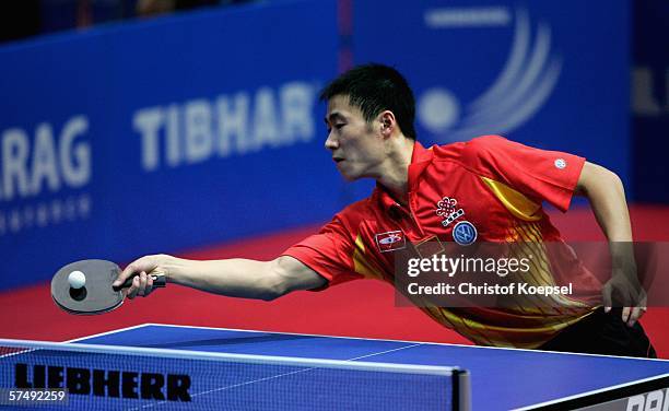 Wang Liqin of China plays a forehand against Damian Eloi of France during the sixth day of the Liebherr World Team Table Tennis Championships at the...