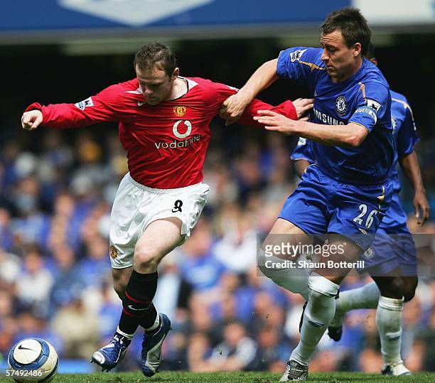 Wayne Rooney of Manchester United holds off the challenge of John Terry of Chelsea during the Barclays Premiership match between Chelsea and...