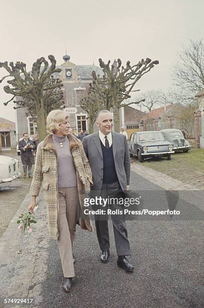 French politician and Prime Minister of France, Georges Pompidou pictured with his wife Claude Pompidou as they make their way to vote in the French...
