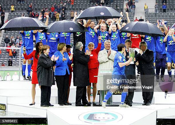 Angela Merkel and other officials celebrate the victory of Turbine Potsdam during the Women's DFB German Cup final between 1.FFC Turbine Potsdam and...