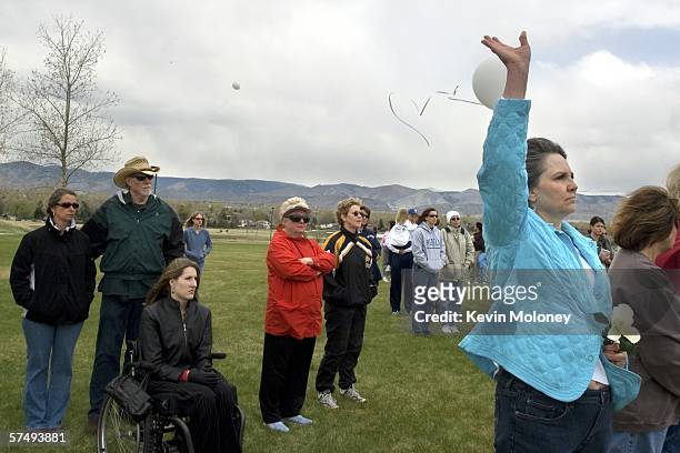 Patricia DePooter, mother of Columbine shooting victim Corey DePooter releases a balloon as her son's name is called among the victims at a...