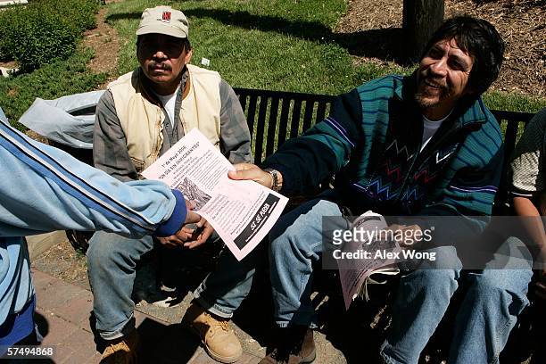 Arnoldo Borja , a community organizer of Virginia Justice Center, hands out flyers of the May 1st boycott to Latino day laborers as they wait for...