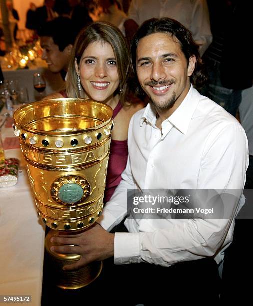 Claudio Pizarro and his wife Karla Salcedo pose with the trophy during the Bayern Munich party after the German Cup final between Bayern Munich and...